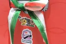 داور بین المللی تیراندازی با نماد کودکان میناب در بازی های آسیایی حضور یافت