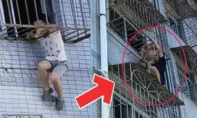 آویزان ماندن کودک از حفاظ طبقه ششم ساختمان / ویدئو