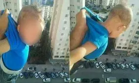 مردی فرزندش را از پنجره یک برج آویزان کرد تا چند لایک بیشتر بگیرد