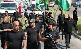 گردان های امام علی سلاح خود را به دولت عراق تحویل می‌دهد