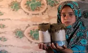 دختری که پاهایش قطع بود و با قوطی کنسرو راه میرفت + تصاویر