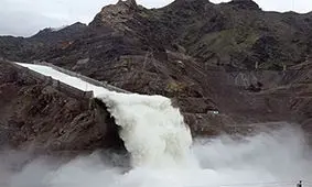 قایقی که نزدیک بود از سد سرریز شده از آب به پایین پرتاب شود + فیلم