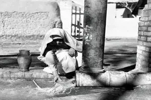 پیرمرد تهرانی در حال پر کردن کوزه از آب چاه؛ سال ۱۳۴۰
