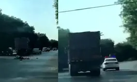 لحظه له شدن مامور پلیس زیر چرخ های کامیون/ ویدئو